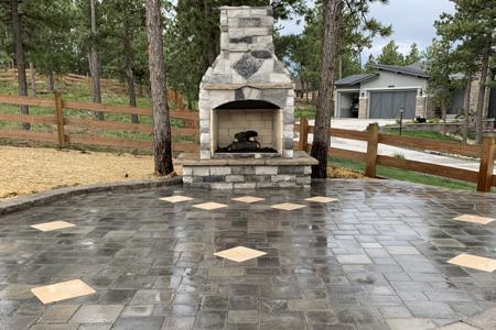 Paver patio, veneer stoned fireplace for a gas insert in Monument Colorado