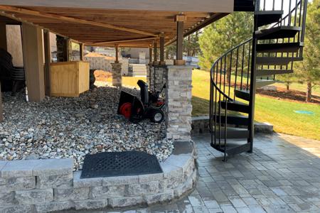 Paver patio, veneer stoned deck pillars and a segmental retaining wall, changed the back yard view for this Monument, Colorado home