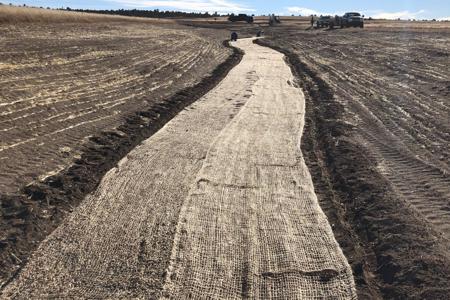 Installed special erosion control blanket in a large ditch in Black Forest, Colorado to slow down the erosion and get grass to grow