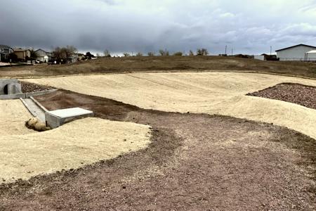 Erosion Control Colorado Springs. Installed erosion control blanket and straw waddles on a pond in Colorado Springs to help with grass seed germination.