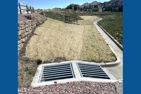 Erosion Control in Monument, Colorado. Installed erosion control blankets in a pond in Monument, Colorado to stop the erosion of dirt moving into the concrete area when it rains and allow for grass to grow in the area