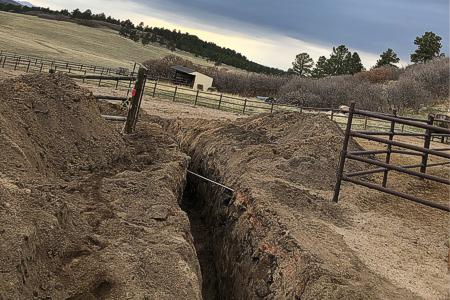 Installing a water line in a pasture in Larkspur, Colorado