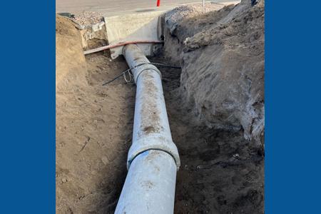 Excavating in Colorado Springs with the installation of new RCP into existing structure. Hole drilled and then installation of the RCP around the communication lines that were in the way. 