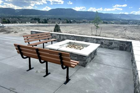 Commercial landscape in Monument, Colorado with a natural gas firepit installed in a communal space for the homeowners. 