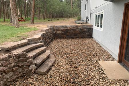 Retaining wall in Monument, Colorado. This segmental retaining wall was to create more usable space in the back yard as well as allow access with the integrated segmental stairs