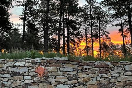 Beautiful sunrise behind a Siloam stone retaining wall in Monument, Colorado.