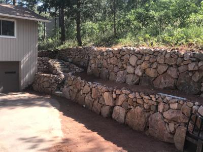Boulder retaining wall with stairs in Perry Park Colorado